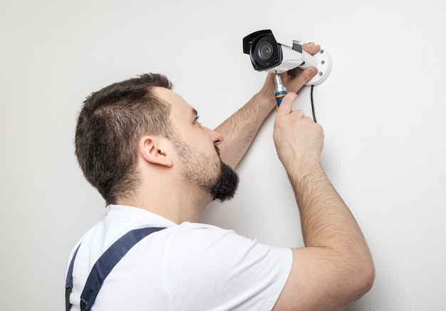 premium-photo-technician-worker-installing-video-surveillance-camera