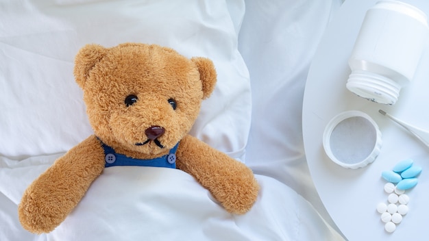 Teddy bear is ill from the flu and virus infection Premium Photo