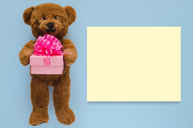 teddy bear holding a box