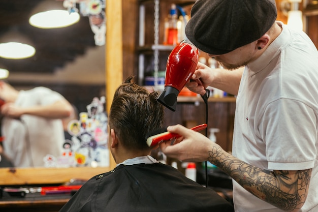 Premium Photo | Teenage boy haircuts hairdresser in the barber shop