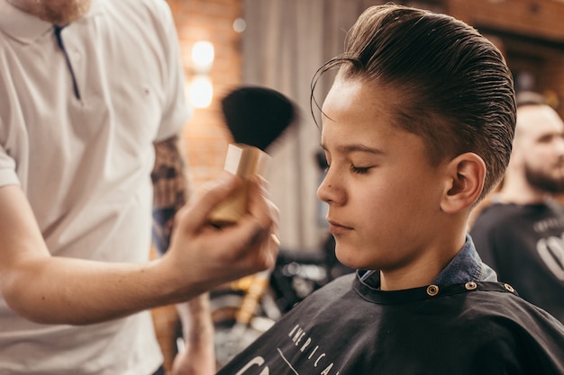 Teenage Boy Haircuts Hairdresser In The Barber Shop Premium Photo
