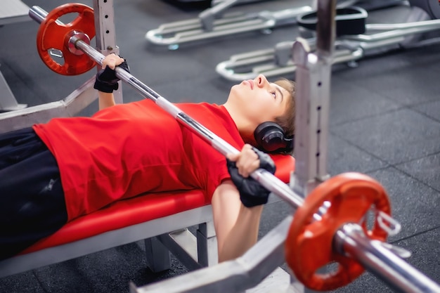 Premium Photo | Teenage boy training in the gym