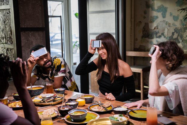 Premium Photo Teenage Friends Playing A Word Guessing Game At The Dinner Party