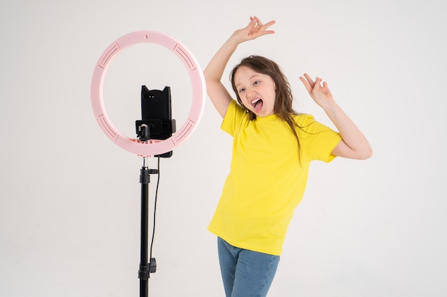 Premium Photo Teenage Girl Dances And Shoots A Video Phone Is Mounted On A Tripod And The Ring Lamp Shines