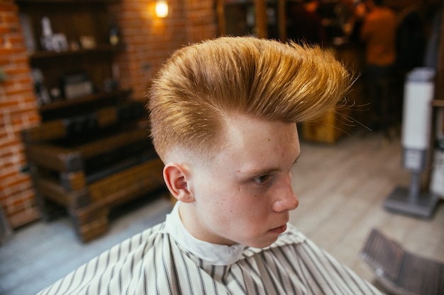 Teenage Redhead Boy Haircuts Hairdresser In The Barber Shop