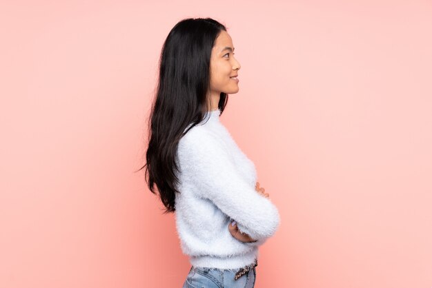 Teenager Chinese Woman Isolated On Pink Wall In Late