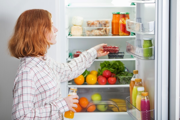 Premium Photo | Teenager girl at fridge with food