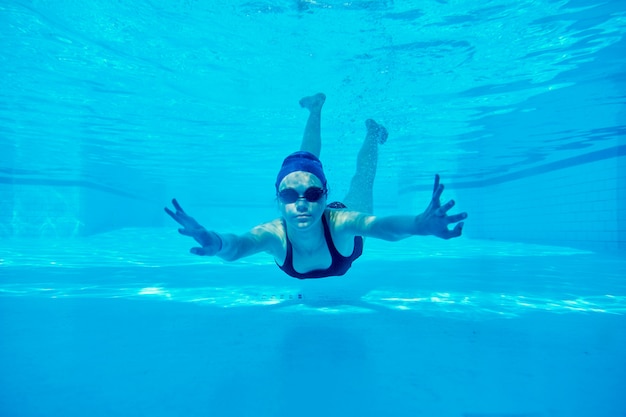 Premium Photo | Teenager girl swimming underwater in pool