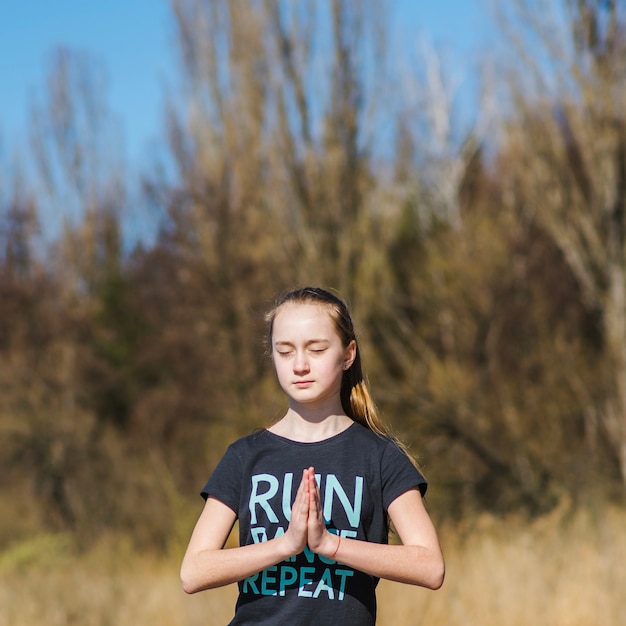 Free Photo | Teenager meditating in nature