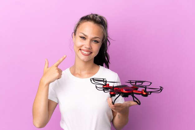Premium Photo | Teenager russian girl holding a drone isolated on ...