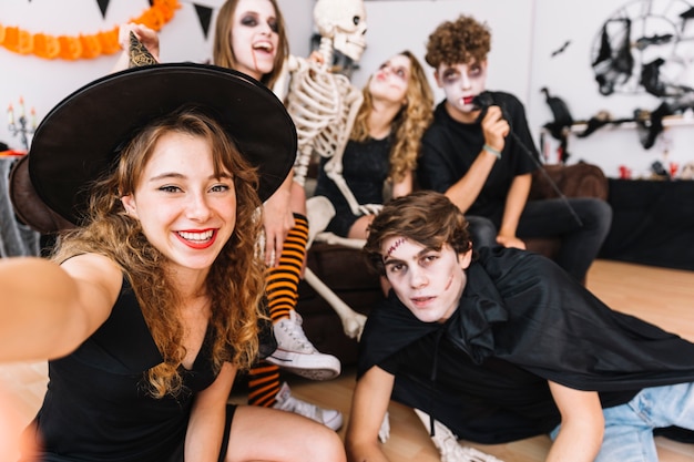 Free Photo Teenagers In Halloween Costumes Doing Selfie On Floor 1371