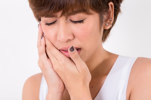 Teeth problem. woman feeling tooth pain. isolated on white. studio lighting. concept for healthy and medical Premium Photo