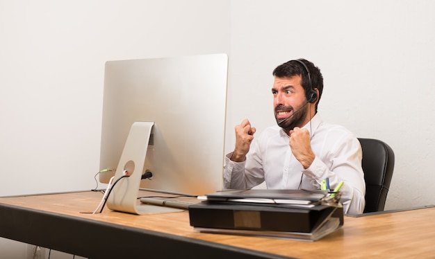 Telemarketer man in a office frustrated by a bad situation Premium Photo