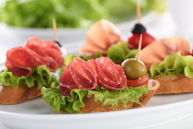 Premium Photo Tender Baguette Canapes With Leaf Lettuce Salami Or