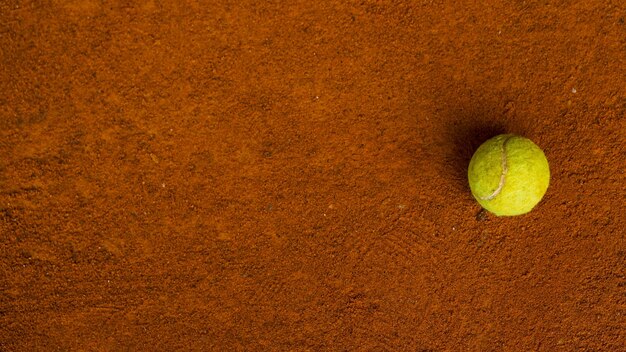 Premium Photo Tennis Ball On The Orange Ground In A Tennis Court