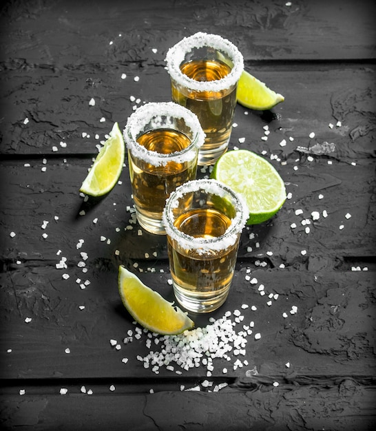 Premium Photo | Tequila in a shot glass with salt and slices of fresh ...