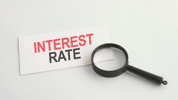 Text interest rate on the white paper card, on lens background, bisiness concept Premium Photo
