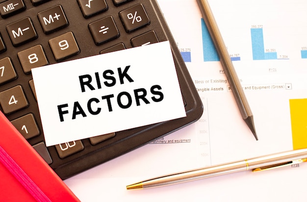 premium-photo-text-risk-factors-on-white-card-with-metal-pen