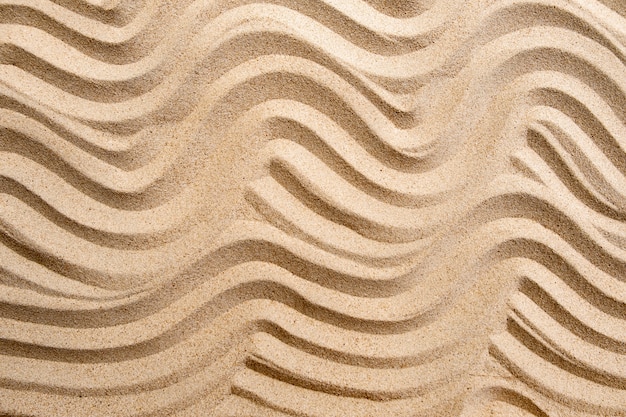 Texture line wave sand on the beach, nature surface background Premium Photo