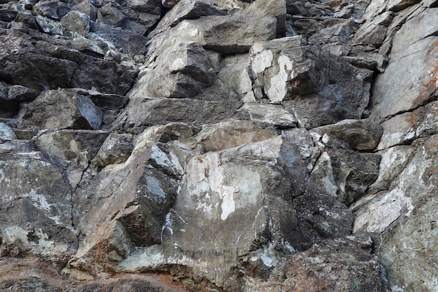 天然石の岩の背景の壁紙のテクスチャ白灰色と黒の水しぶきの表面の水平方向の長方形の写真 プレミアム写真