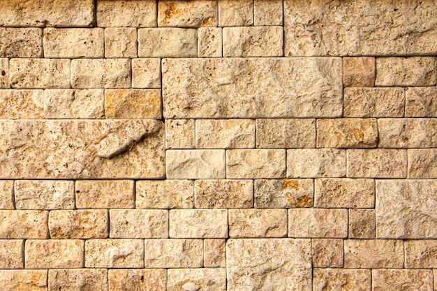  Texture of stone wall, square yellow travertine tile.