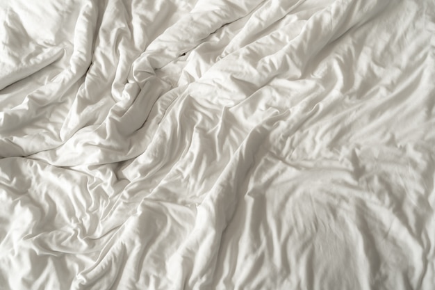 Premium Photo | The texture of the white bedsheet is wrinkled.