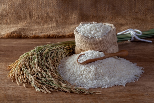 Premium Photo | Thai jasmine rice in a sack on a wooden background
