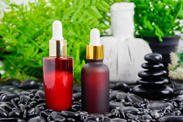 Premium Photo Thai Spa Massage Setting With Red Serum Oil Bottle Dropper Mock Up Or Essential