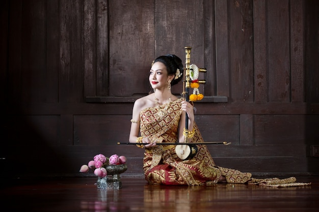 Premium Photo Thai Women Traditional Costume Sitting In Wooden House