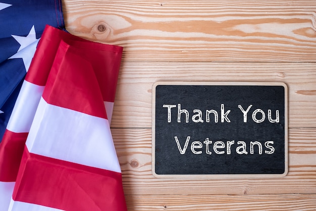 Premium Photo | Thank you veterans text written in chalkboard with flag ...