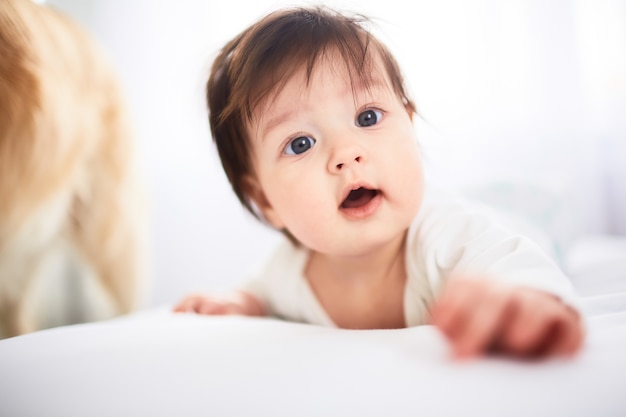 The small baby lies on the bed Free Photo The small baby lies on the bed Free Photo