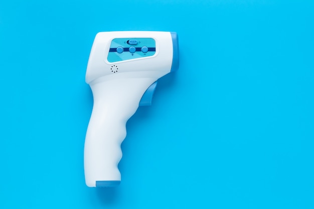 Thermometer gun for measuring temperature. infrared non contact electronic thermometer, covid-19 testing. concept of pandemic of coronavirus. Premium Photo