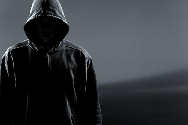 Premium Photo | Thief in black clothes on grey background