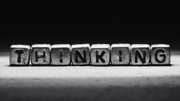 Premium Photo | Thinking concept lettering on metal cubes isolated on ...