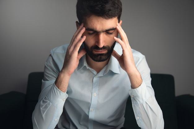 Premium Photo | Thinking young man hand in head sitting on a sofa