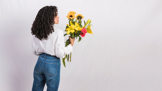 Free Photo Thoughtful Black Woman Holding Flowers Bouquet