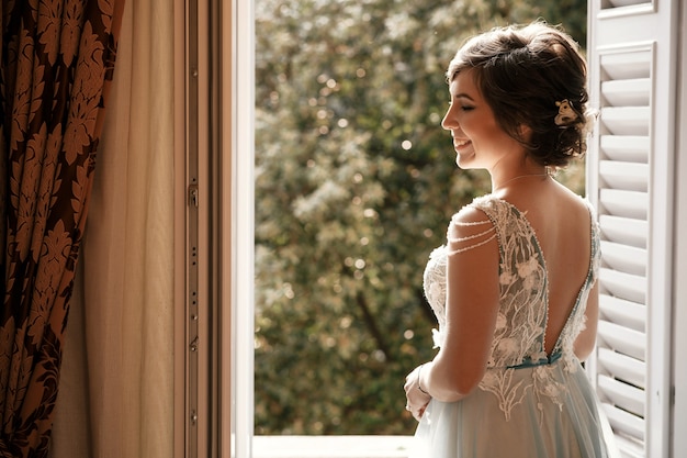 Thoughtful bride stands before an open window in the ...
 Open Window At Morning