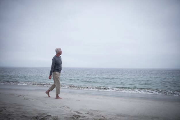 Premium Photo | Thoughtful retired man walking on the beach