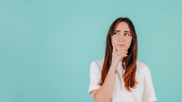 Thoughtful woman in white T-shirt Free Photo