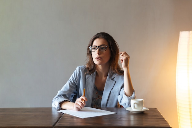 Free Photo | Thoughtful woman writing notes.