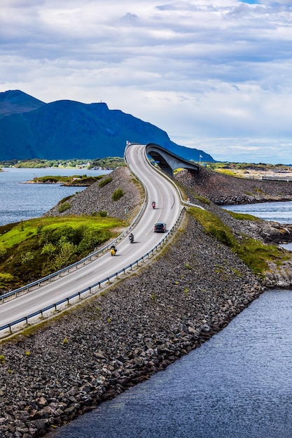 Premium Photo | Three bikers on motorcycles. atlantic ocean road or the ...