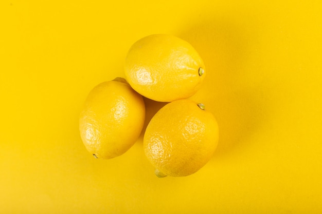 Free Photo | Three fresh bright lemons on yellow