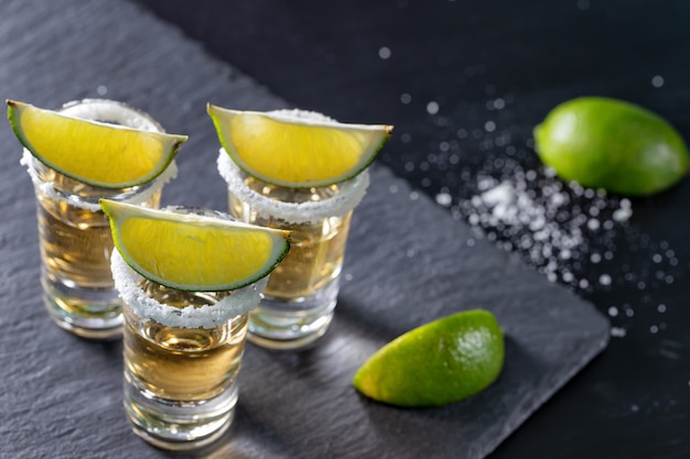 Premium Photo | Three glasses of mexican tequila and lime