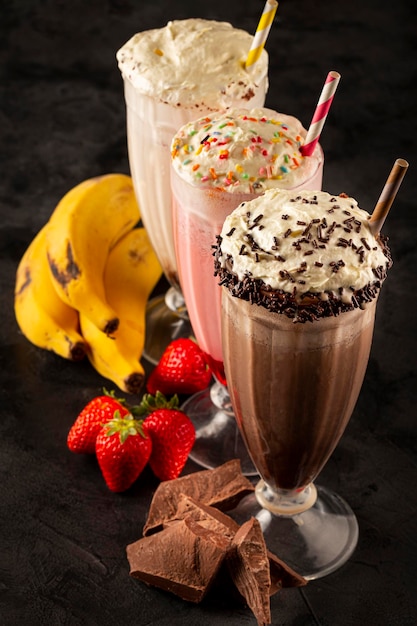 Premium Photo Three Glasses Of Milkshake With Assorted Flavors Chocolate Vanilla And 