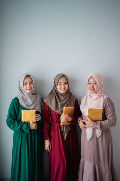 Premium Photo Three hijab  women  smilling hold the holy 