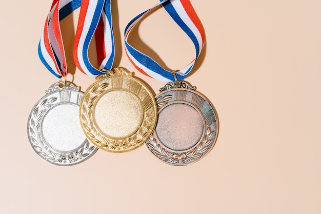 Premium Photo | Three medals (gold,silver,bronze) on pastel background ...