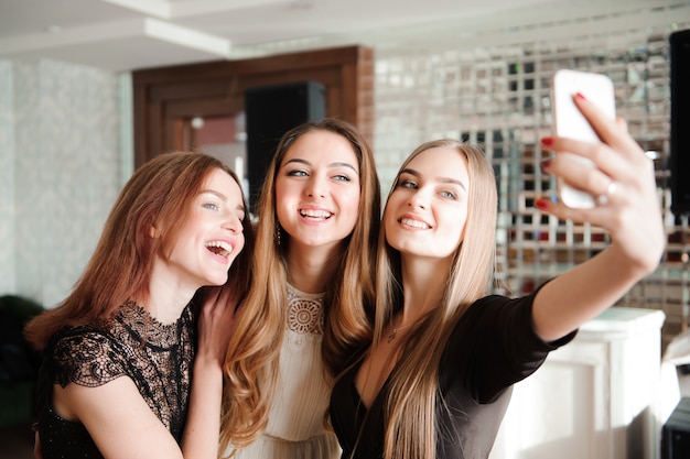 Premium Photo | Three young girls are doing selfie photo in a restaurant