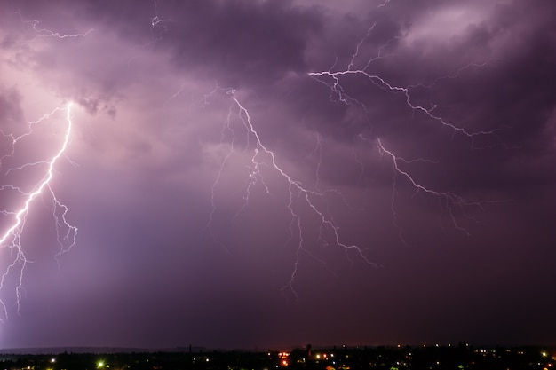 Thunderstorm with lightning in the sky over a small town Premium Photo