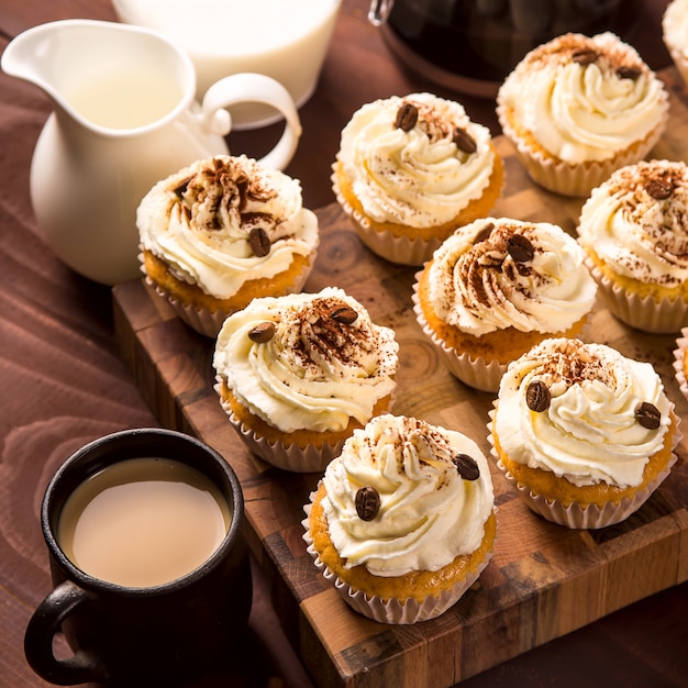 ココアパウダーとコーヒーの穀物で飾られたティラミスカップケーキ プレミアム写真
