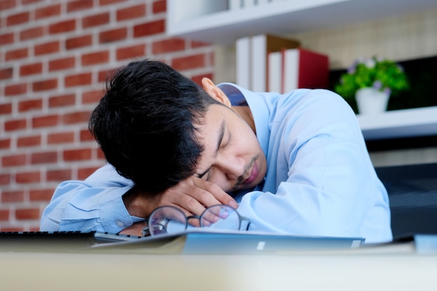 Tired Asian Man Sleeping At Office Desk Young Businessman With